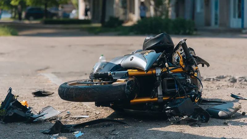 Crashed motorcycle on street.